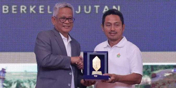 Direktur Utama Holding Perkebunan Nusantara III (Persero) Mohammad Abdul Ghani (kiri) menyerahkan cenderamata kepada Ketua Umum Asosiasi Petani Kelapa Sawit Perusahaan Inti Rakyat Setiyono di acara Workshop PTPN untuk Sawit Rakyat 