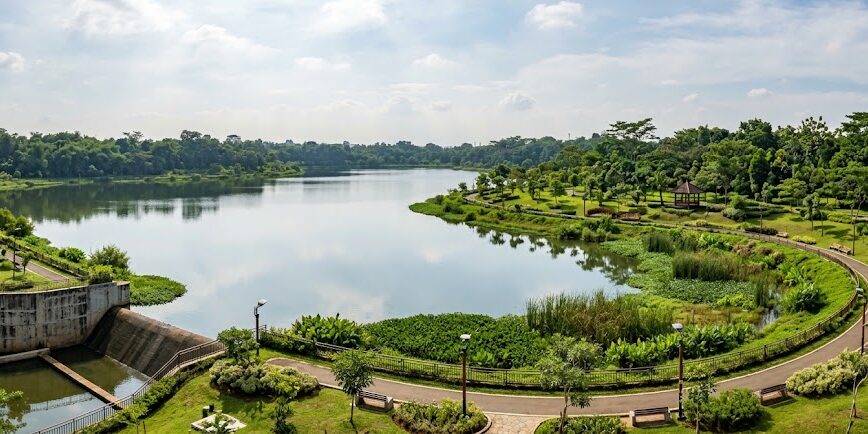 Ilustrasi Pemandangan udara Embung Bambu Hitam di Cipayung, Jakarta Timur, yang berfungsi sebagai pengendali banjir berkonsep nature-based solution sekaligus ruang publik hijau yang asri.